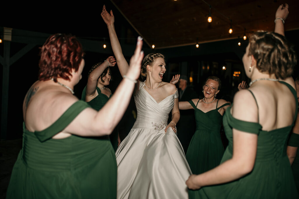 bride dancing with her wedding attendants