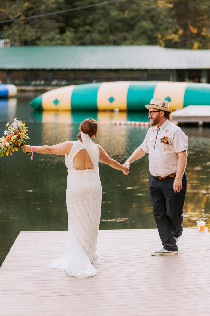 couple on their wedding day standing on a dock
