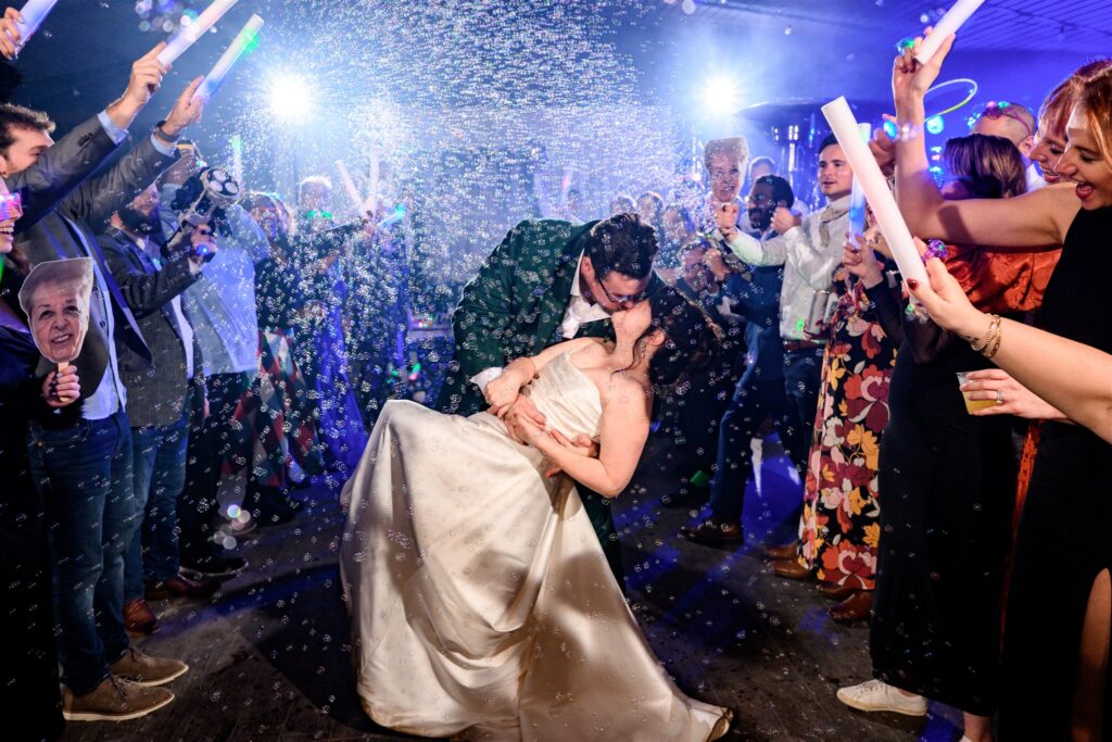 couple kissing during bubble exit at wedding